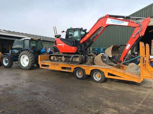 Tractor Trailer loaded with a digger